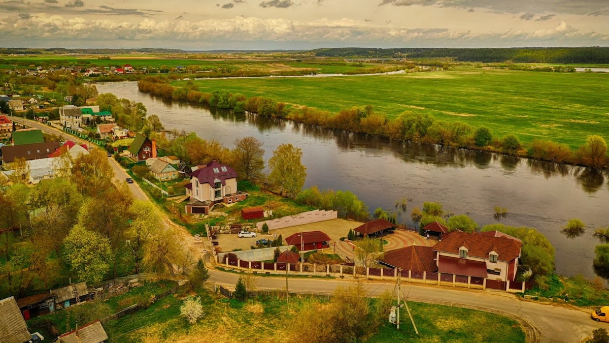a river with houses and trees